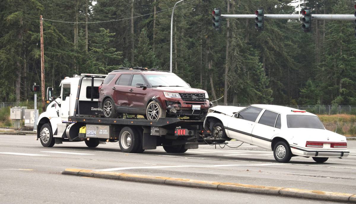 Credit limit towing coverage comparison showing a stranded driver next to a tow truck with a receipt exceeding card reimbursement cap